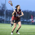 A woman holding a lacrosse stick on a field. Links to Ladies Lacrosse page on Bristol SU Website